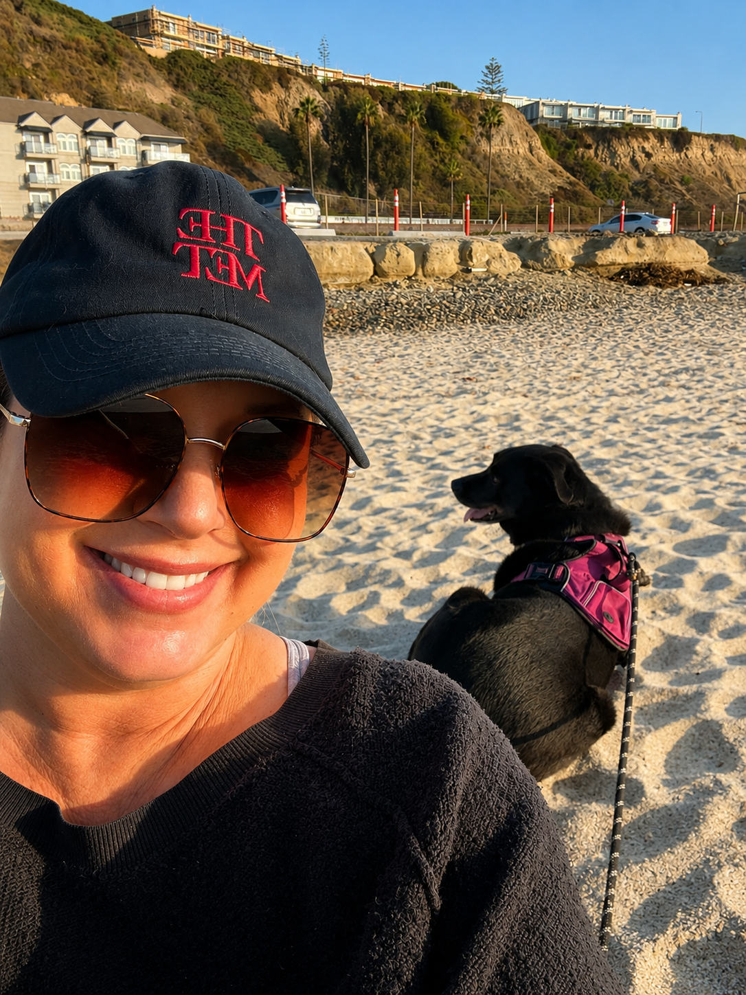 Nicole M. Jones, founder of Honey Bee Brands, at Dana Point beach with her dog